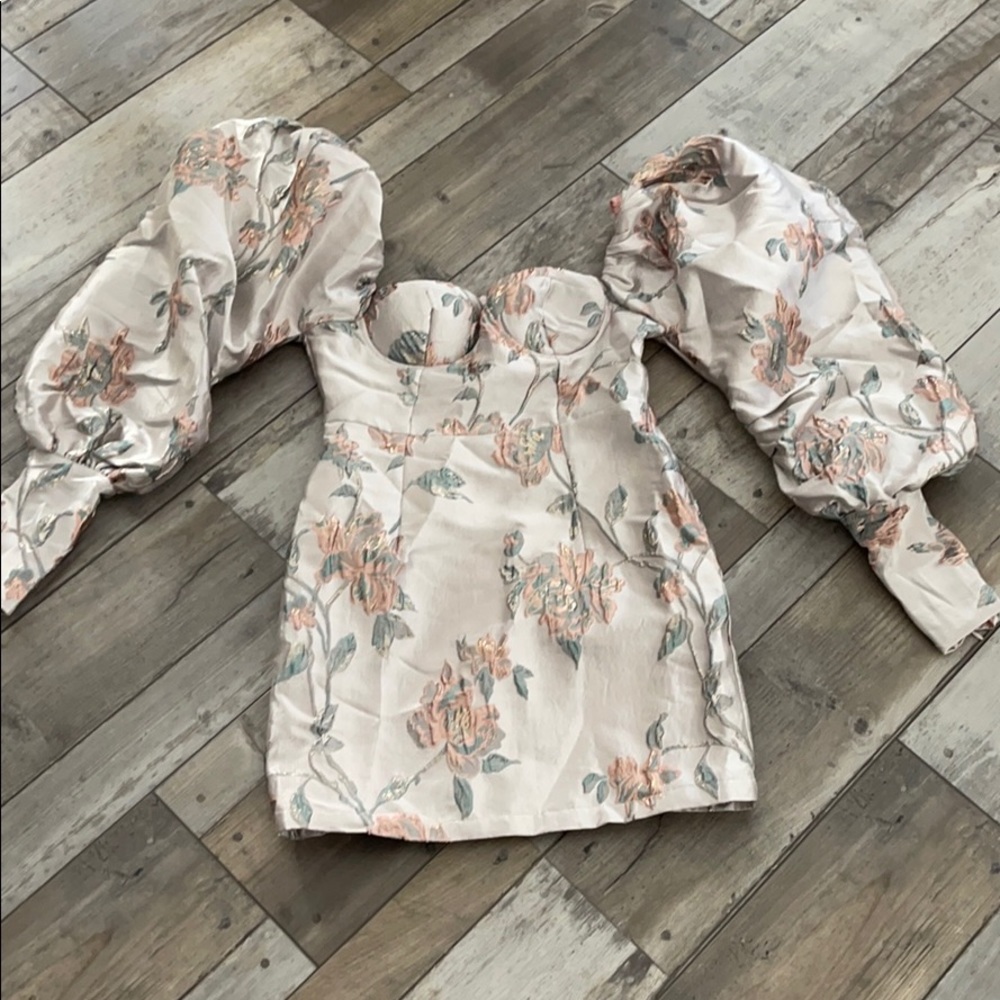 Mini dress with exaggerated puff sleeves.